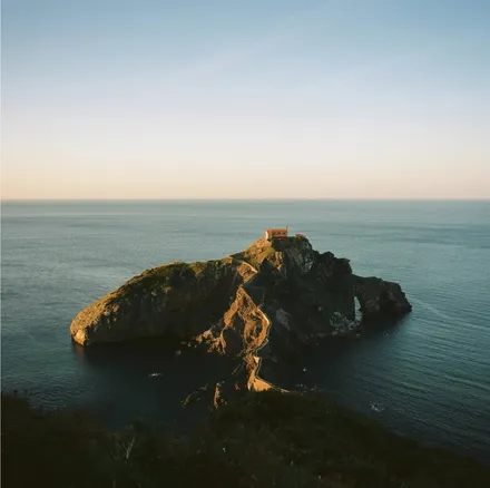 Rocky island with a small chapel, as a print