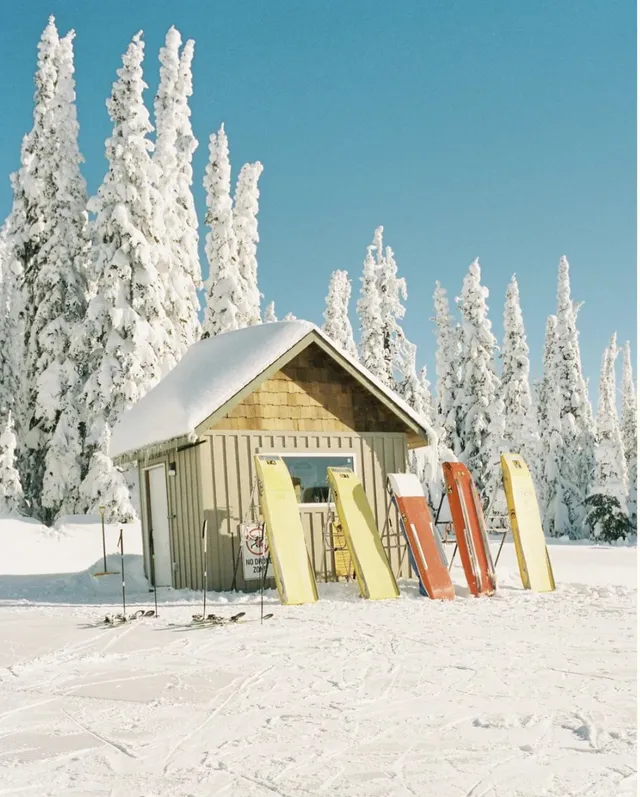 Ski patrol hut with toboggans in snow